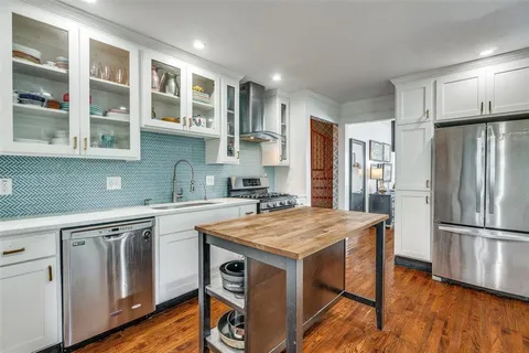a kitchen with a stove a sink and a refrigerator