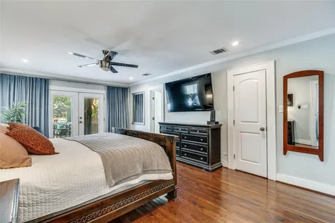 a bedroom with a bed and a flat screen television