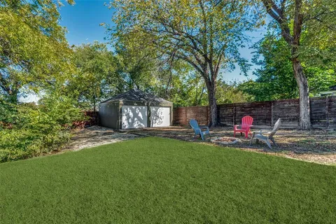 a view of a backyard with table and chairs and a fire pit