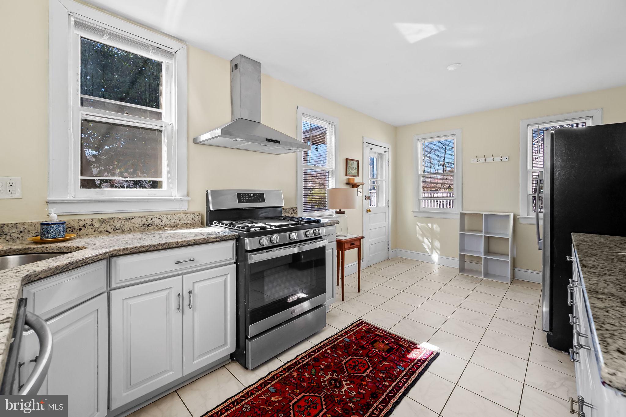 523 Orkney Road Baltimore, MD 21212 - Photo 14 of 40 a kitchen with stainless steel appliances a stove a sink and a refrigerator