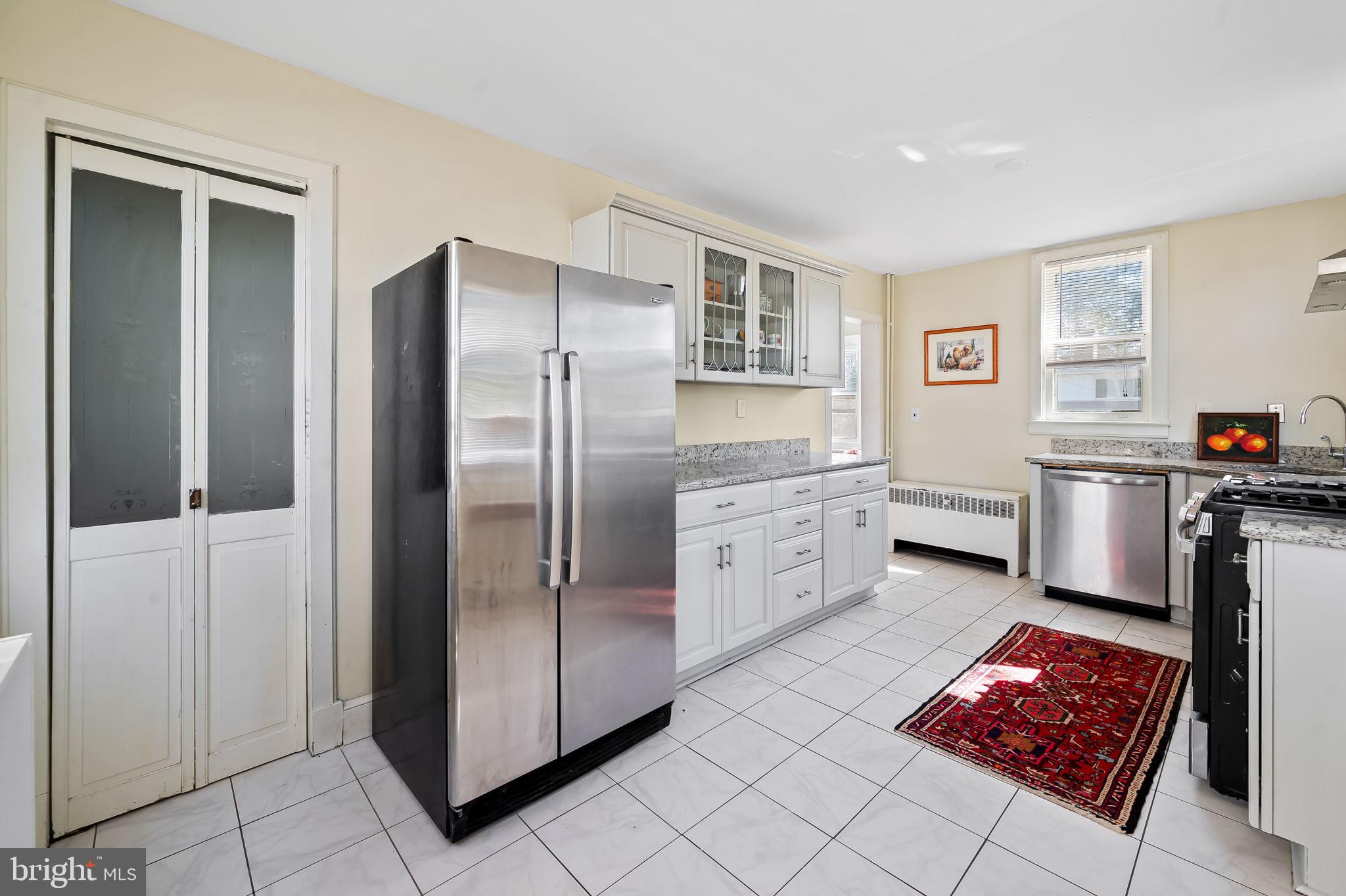 523 Orkney Road Baltimore, MD 21212 - Photo 17 of 40 a kitchen with stainless steel appliances kitchen island granite countertop a refrigerator and a stove top oven