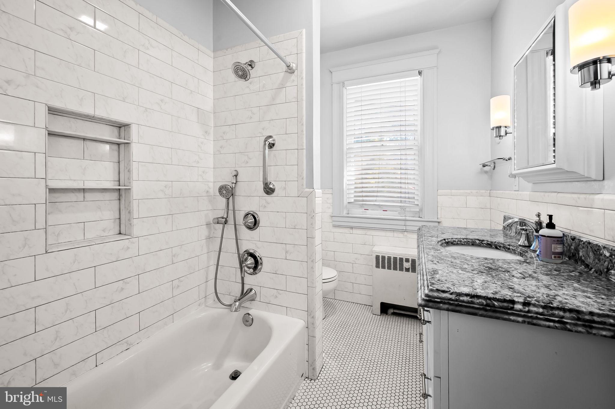 523 Orkney Road Baltimore, MD 21212 - Photo 23 of 40 a bathroom with a granite countertop sink and a bathtub