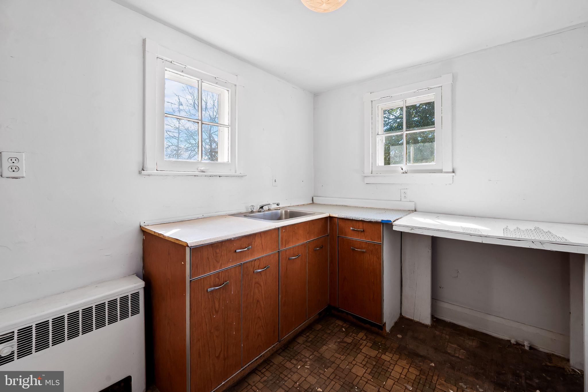 523 Orkney Road Baltimore, MD 21212 - Photo 26 of 40 a utility room with cabinets washer and dryer