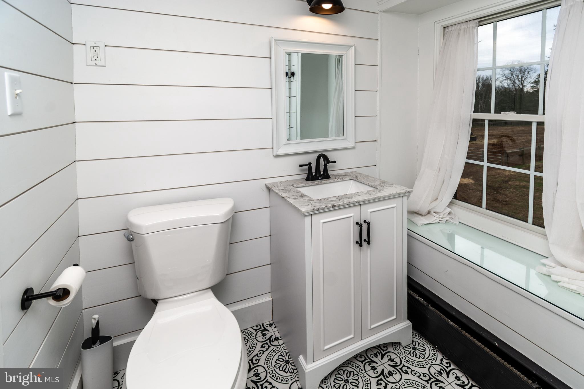 180 Municipal Road Pipersville, PA 18947 - Photo 42 of 60 a white toilet sitting next to a bathroom sink