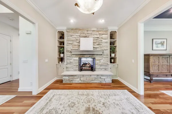 a view of a livingroom with a fireplace and window