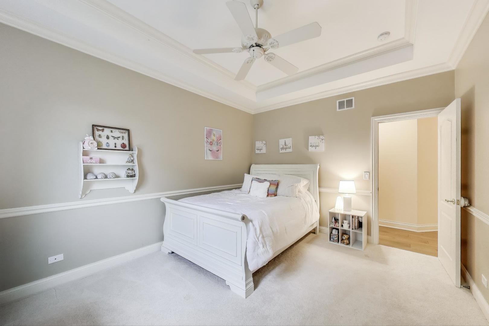 20580 West High Ridge Drive Kildeer, IL 60047 - Photo 35 of 69 a bedroom with a bed and a chandelier