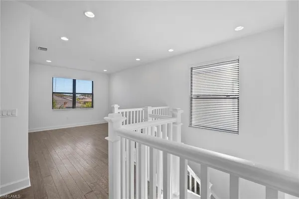 an empty room with chandelier fan