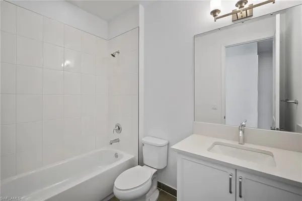 a large bathroom with a large tub sink and window