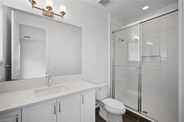 an empty room with a window and a ceiling fan