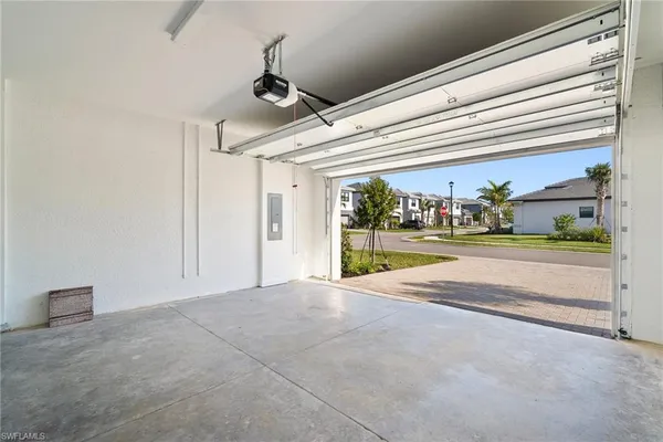 an empty room with windows and ceiling fan