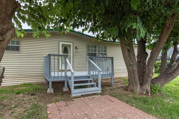 a wooden bench sitting in front of a house