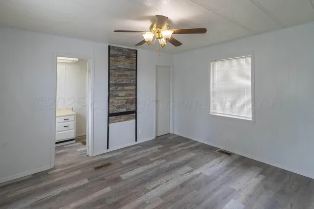 a view of an empty room with a window