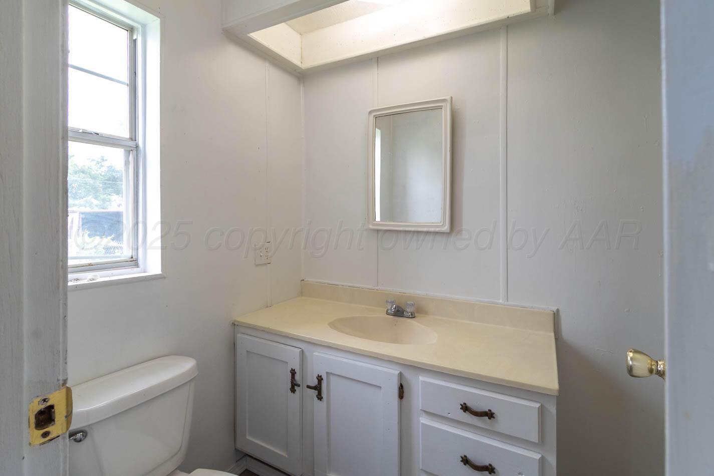 201 Michael Drive Fritch, TX 79036 - Photo 15 of 19 a bathroom with a sink toilet and a window