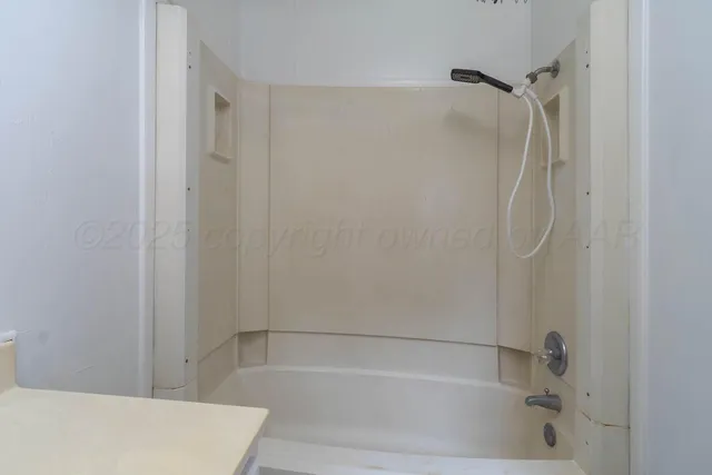 a bathroom with a shower and a bath tub