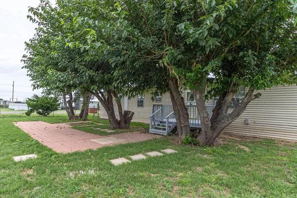 a view of a backyard with large trees