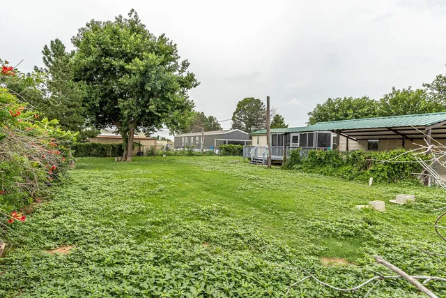 a backyard of a house with table and chairs