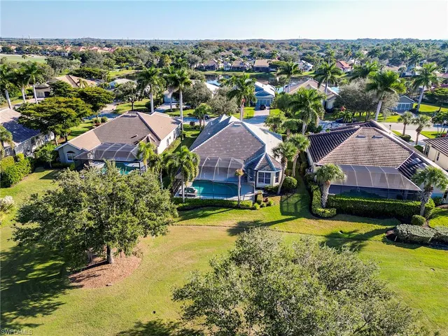 an aerial view of residential houses with outdoor space and pool