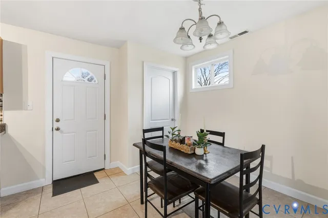 a view of a room that has a table and chairs in it