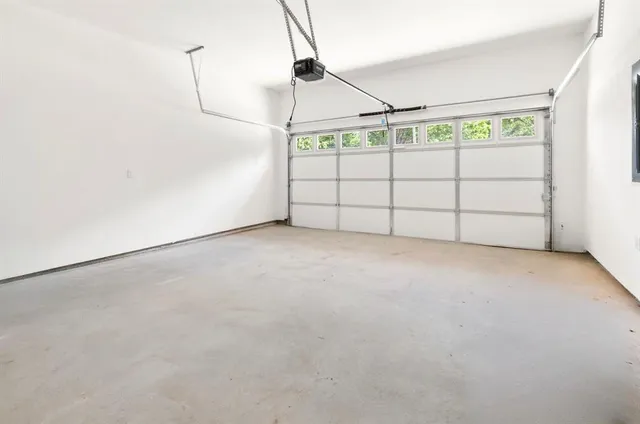 a view of a house with a yard and garage