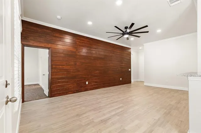 an empty room with closet and fan