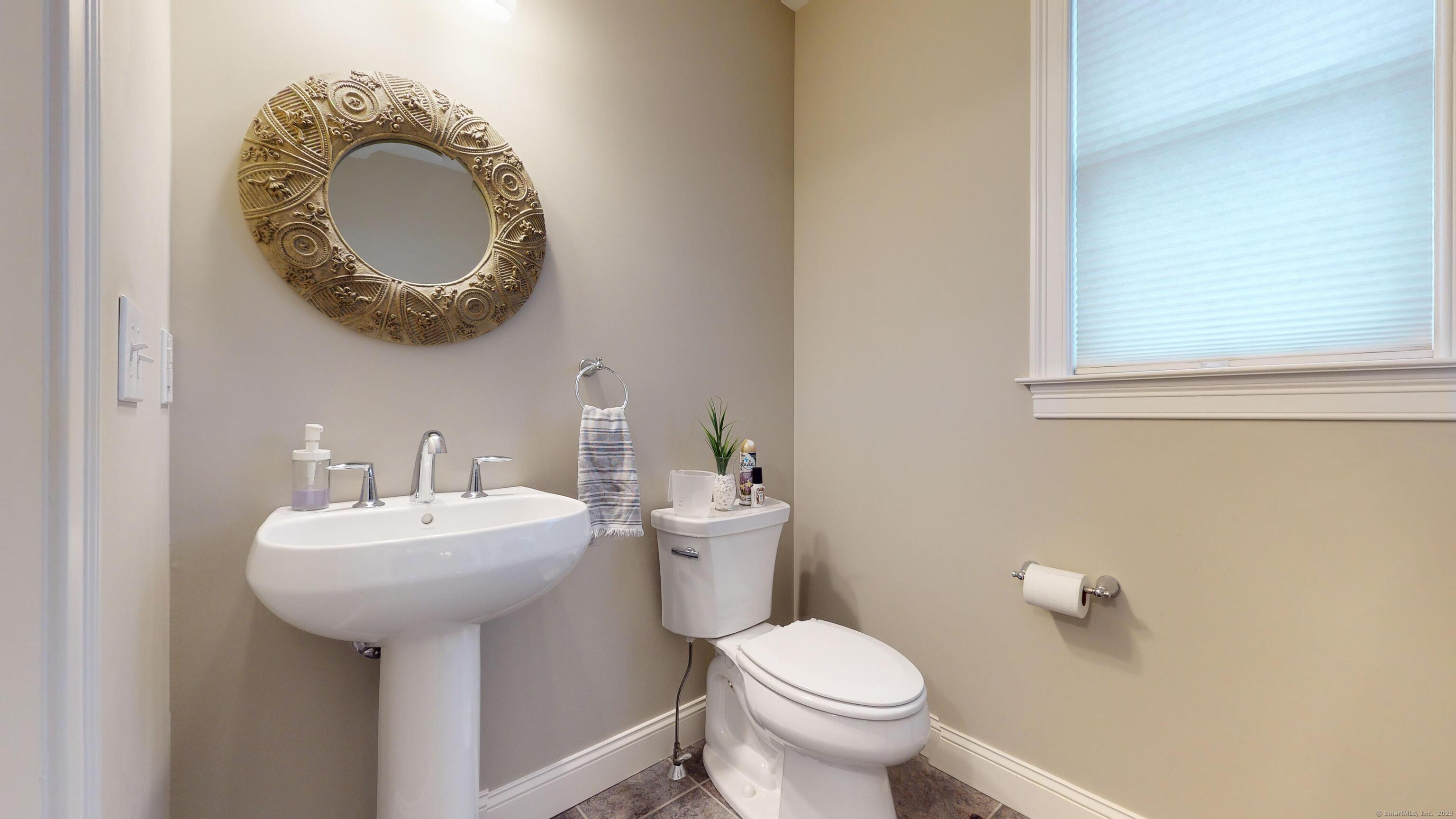 1012 Maple Street Rocky Hill, CT 06067 - Photo 11 of 31 a bathroom with a toilet sink and mirror