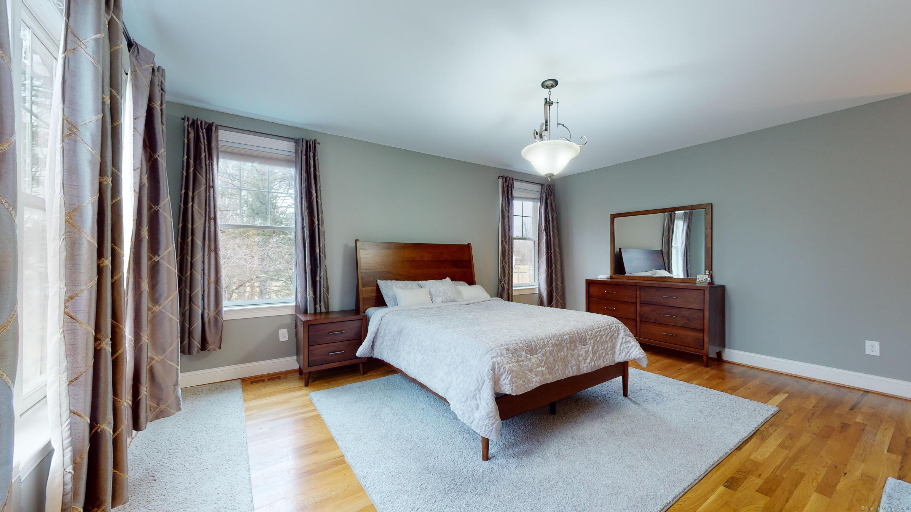 1012 Maple Street Rocky Hill, CT 06067 - Photo 12 of 31 a bedroom with a bed wooden floor and window