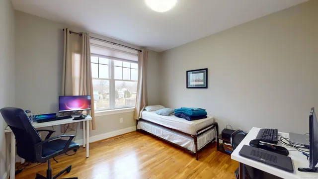 a living room with a bed furniture and a window