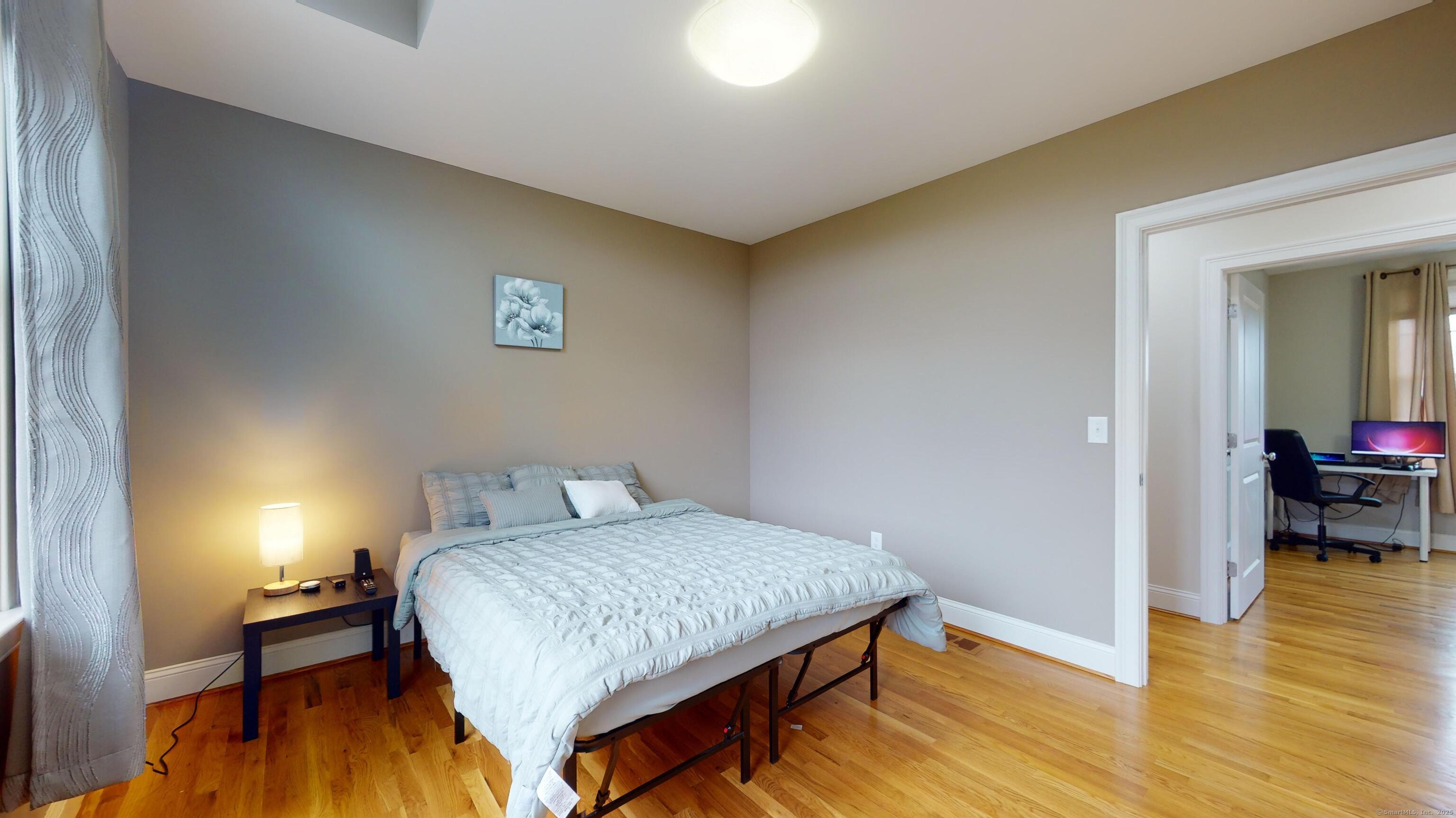 1012 Maple Street Rocky Hill, CT 06067 - Photo 19 of 31 a bedroom with a bed and wooden floor