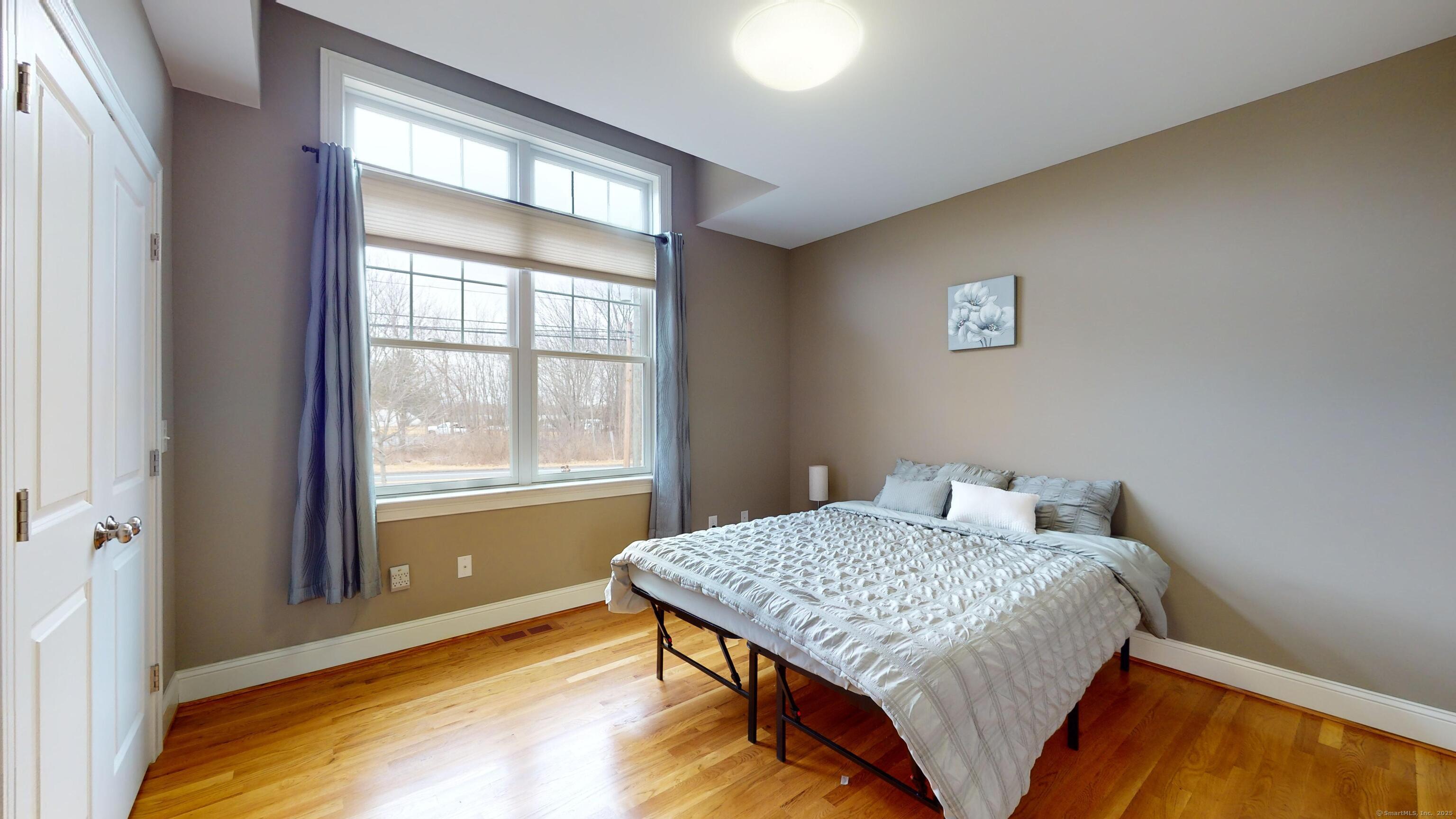 1012 Maple Street Rocky Hill, CT 06067 - Photo 21 of 31 a bedroom with a bed and a window