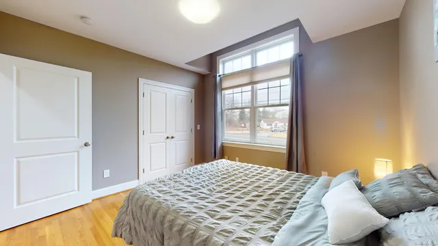 a bedroom with a bed and a window