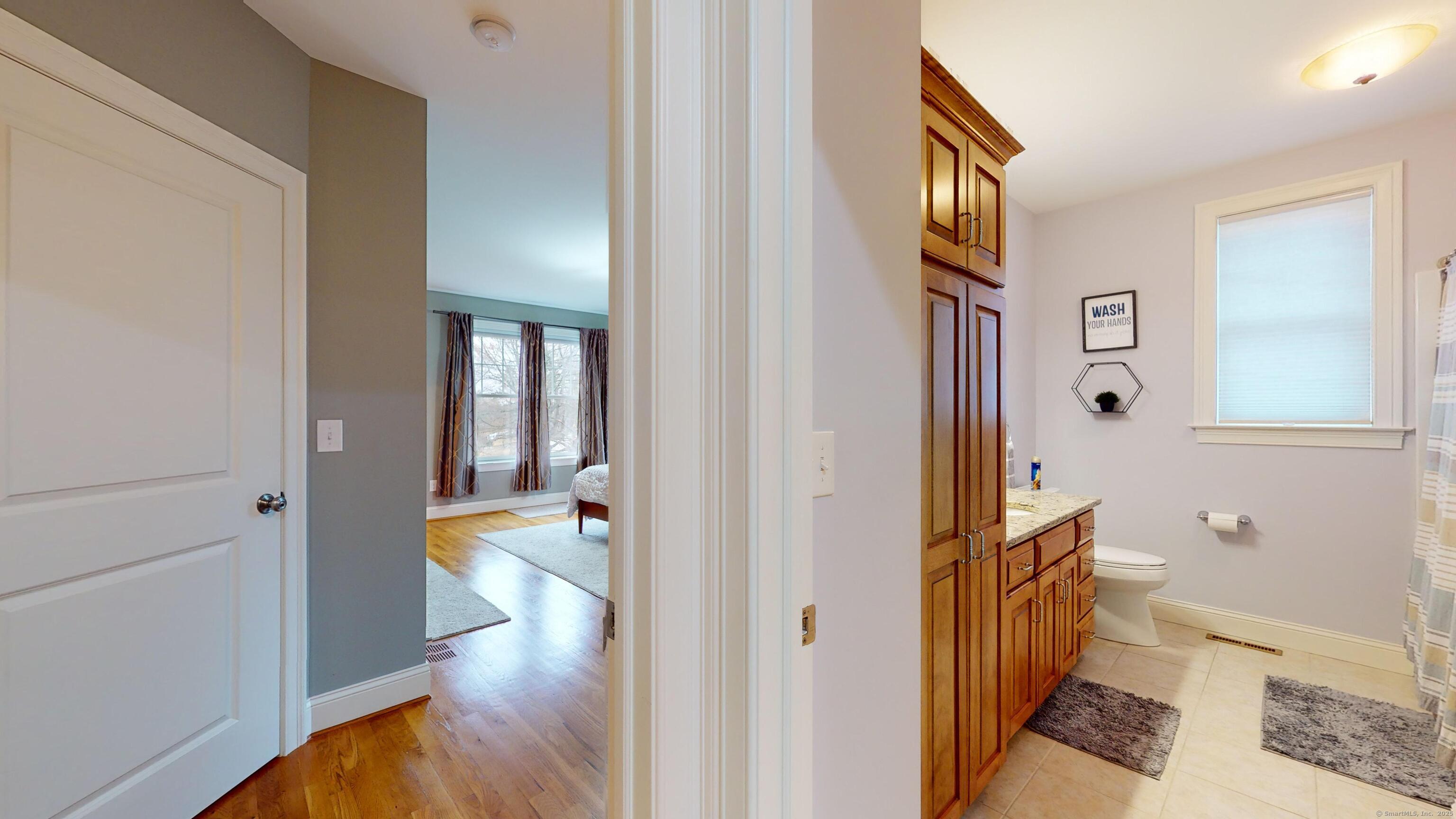 1012 Maple Street Rocky Hill, CT 06067 - Photo 25 of 31 a view of a hallway view with wooden floor and living room