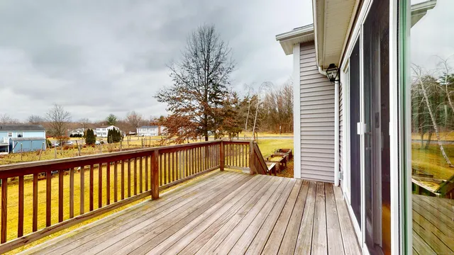 a view of a balcony with wooden floor and fence