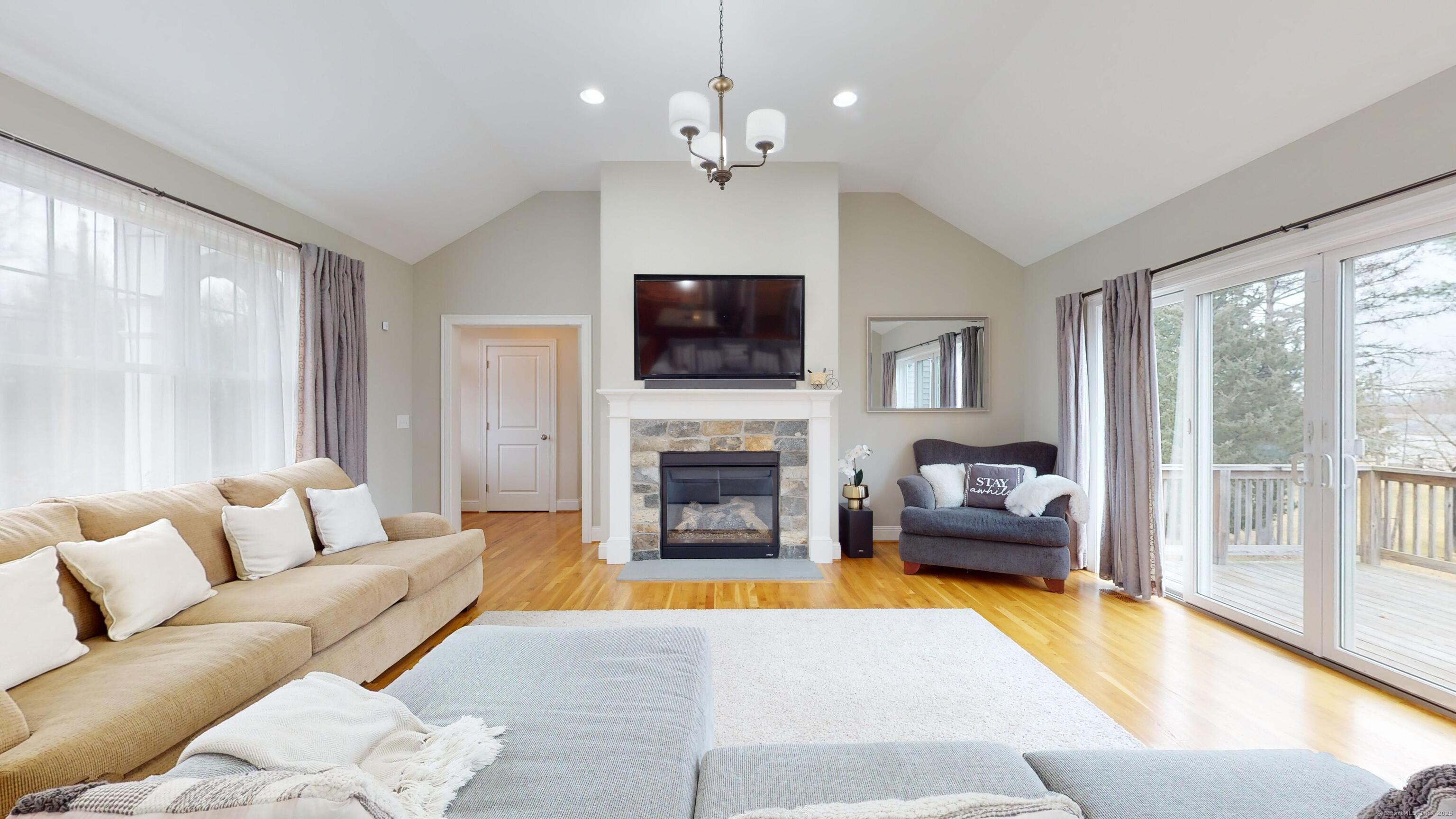 1012 Maple Street Rocky Hill, CT 06067 - Photo 9 of 31 a living room with furniture a fireplace and a flat screen tv