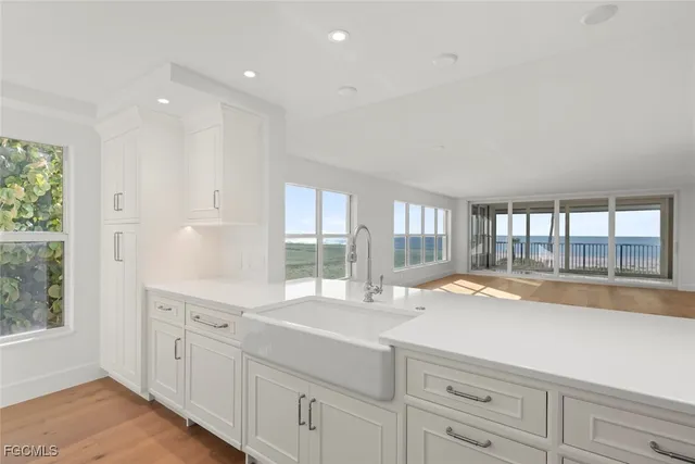 a large white kitchen with a large window