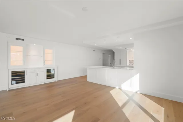 a bedroom with a bed a couch and large window