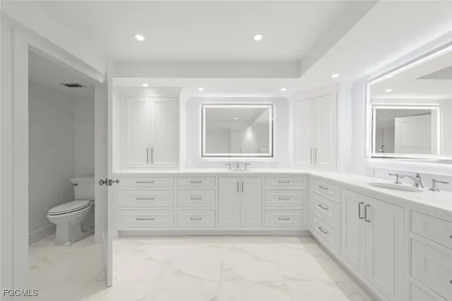 wooden floor with white cabinets and window