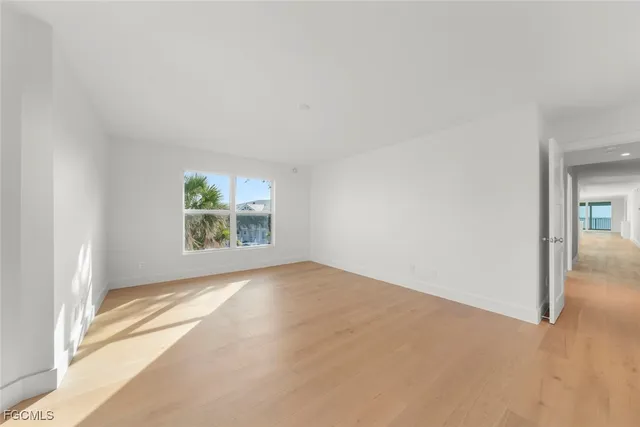 a view of an empty room and wooden floor