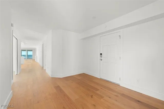 a living room with furniture a flat screen tv and a large window