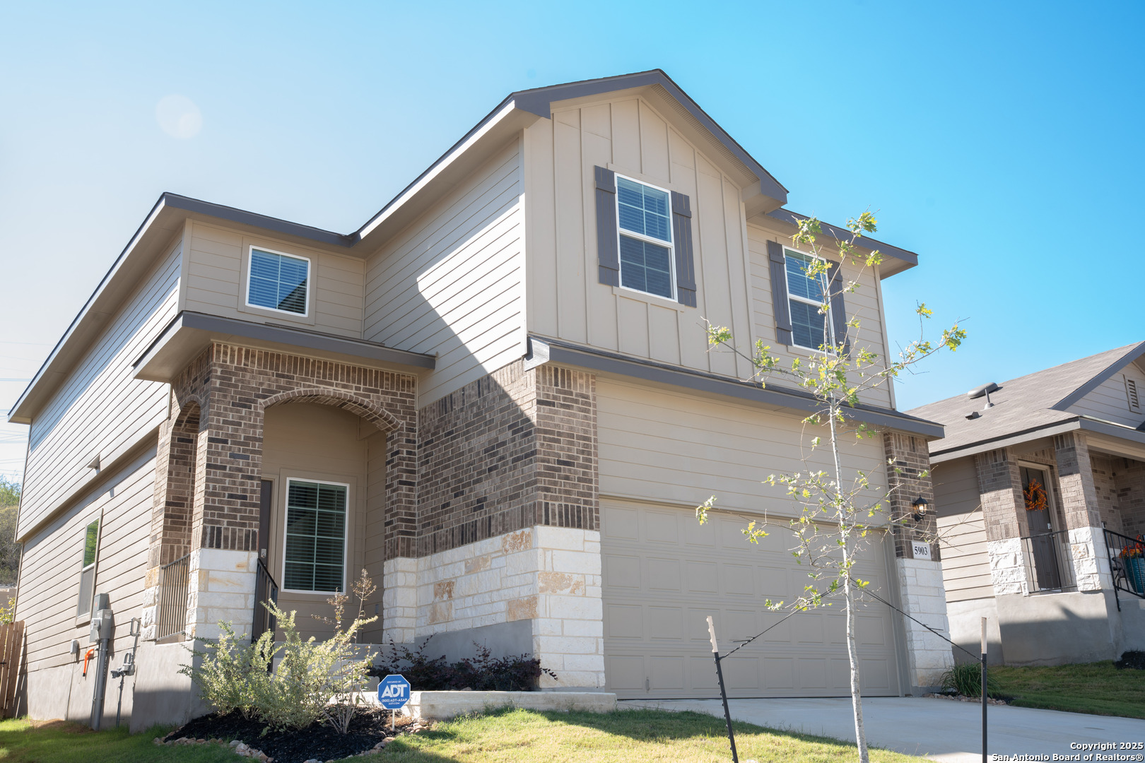 a front view of a house with a garden