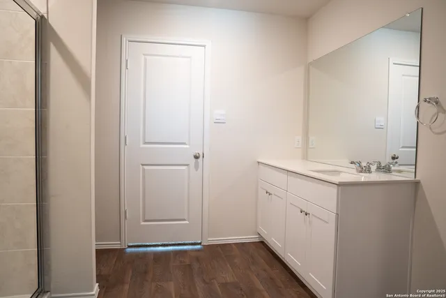 a bathroom with a sink and mirror