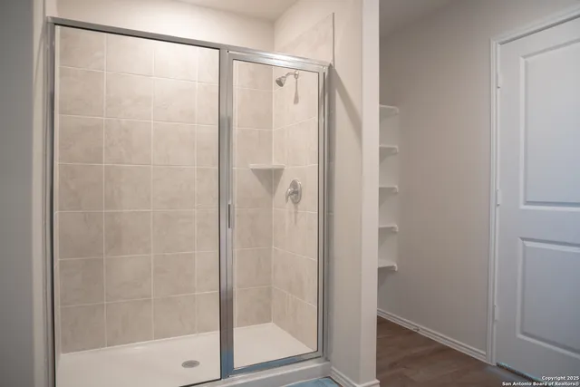 a bathroom with a glass shower door
