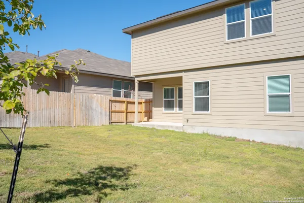 a view of a house with a backyard