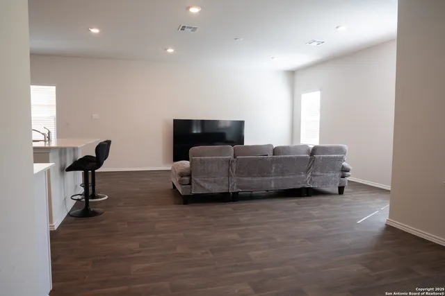 a living room with furniture gym equipment and a flat screen tv