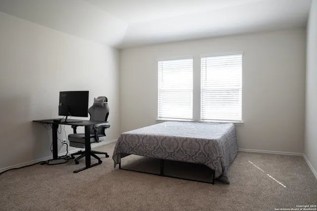 a bedroom with a bed and a desk