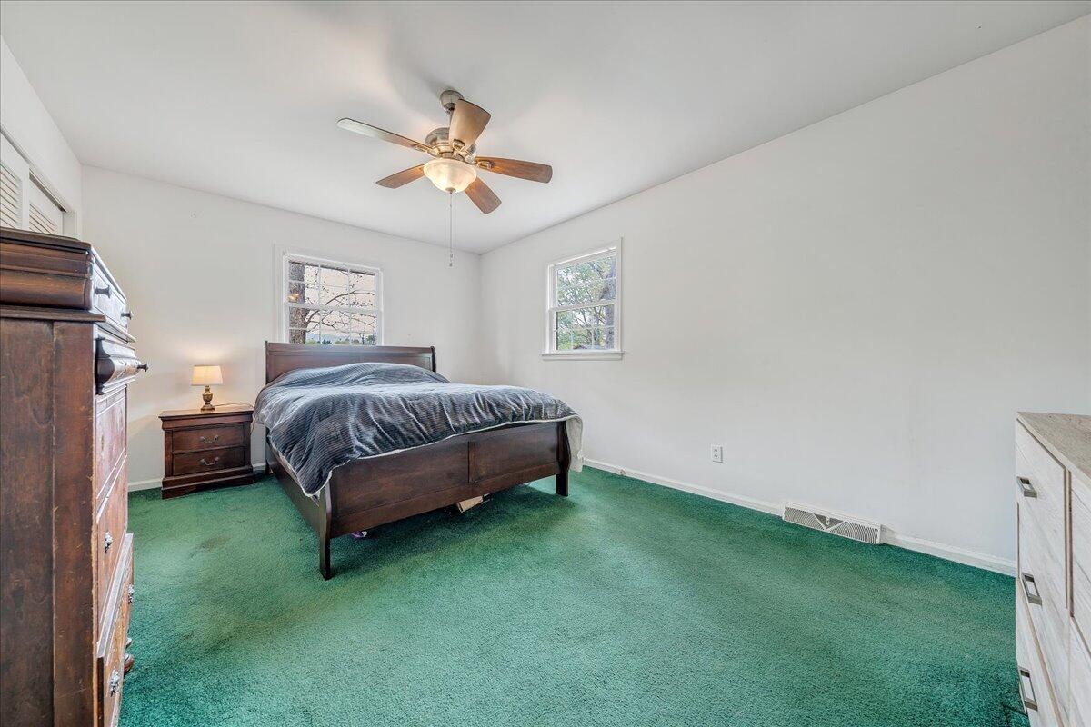 3534 Wedgewood Road Southwest Roanoke, VA 24018 - Photo 16 of 53 a bedroom with a bed and a chandelier