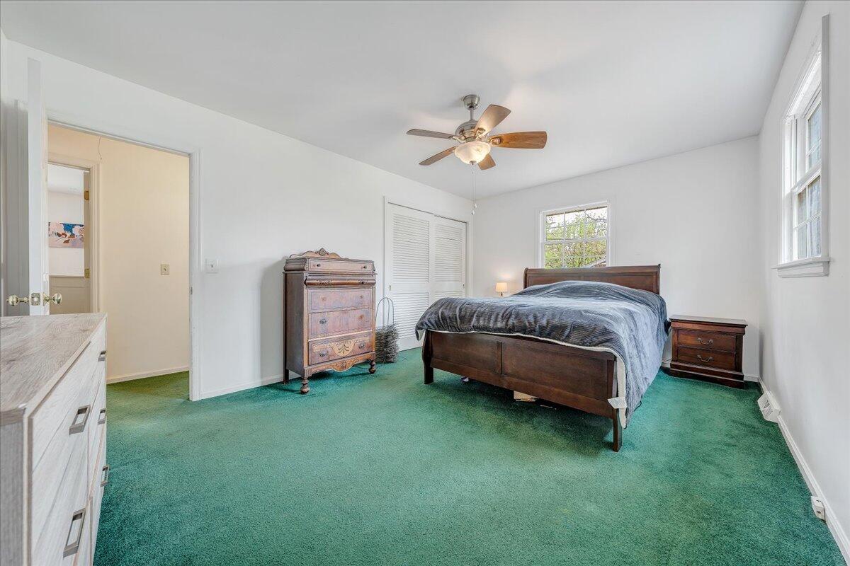 3534 Wedgewood Road Southwest Roanoke, VA 24018 - Photo 17 of 53 a spacious bedroom with a bed and a chandelier