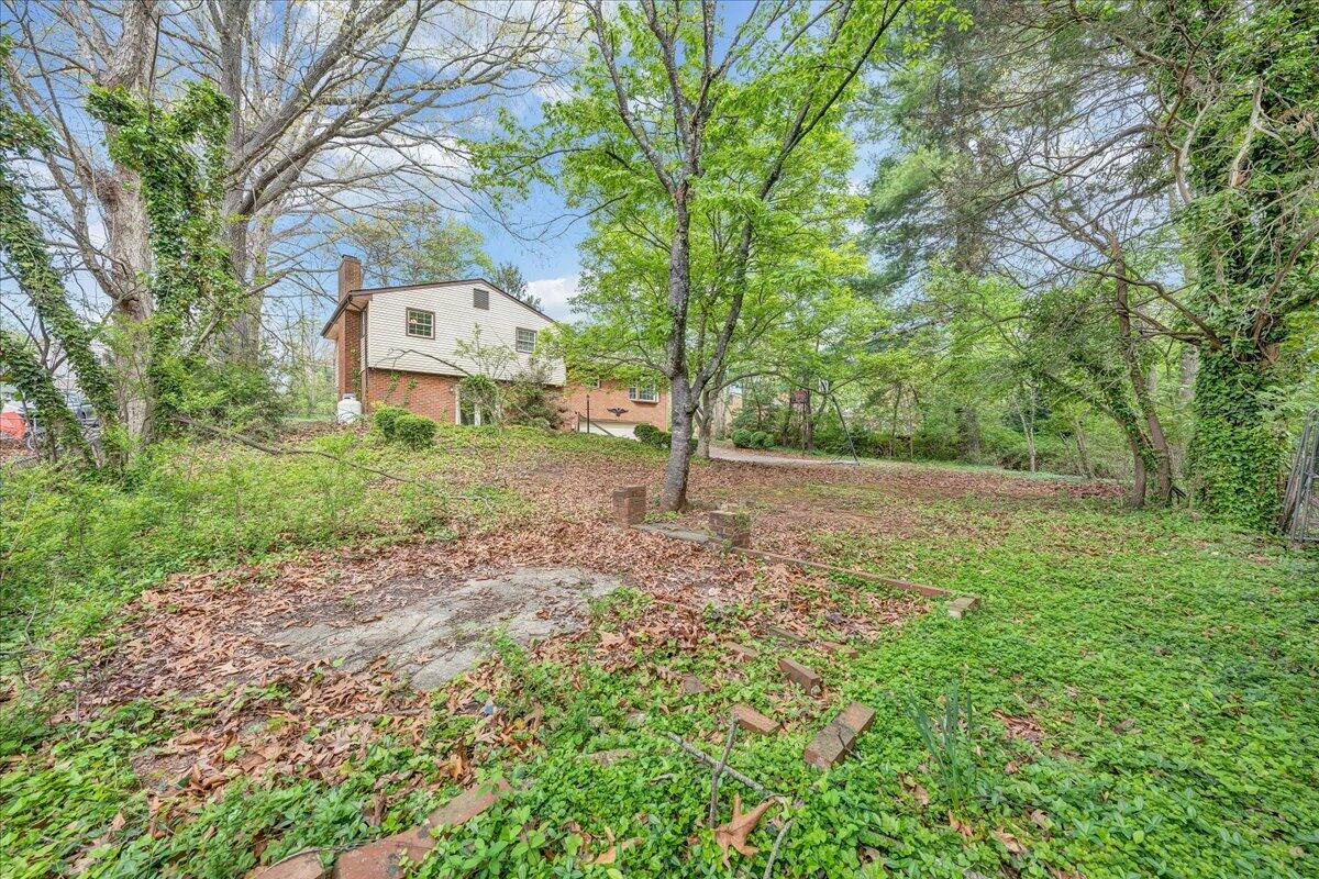 3534 Wedgewood Road Southwest Roanoke, VA 24018 - Photo 35 of 53 a backyard of a house with lots of green space and fountain