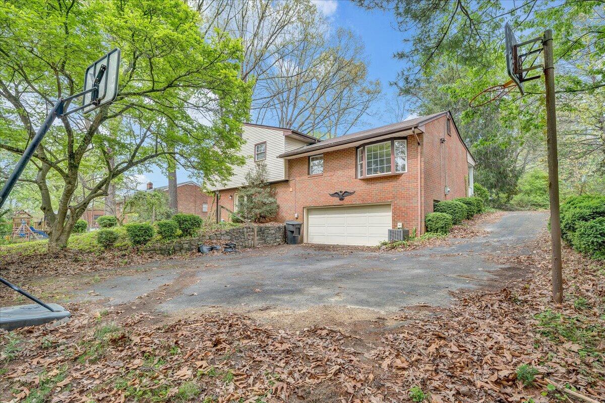 3534 Wedgewood Road Southwest Roanoke, VA 24018 - Photo 36 of 53 a view of a grey house with a yard and large trees