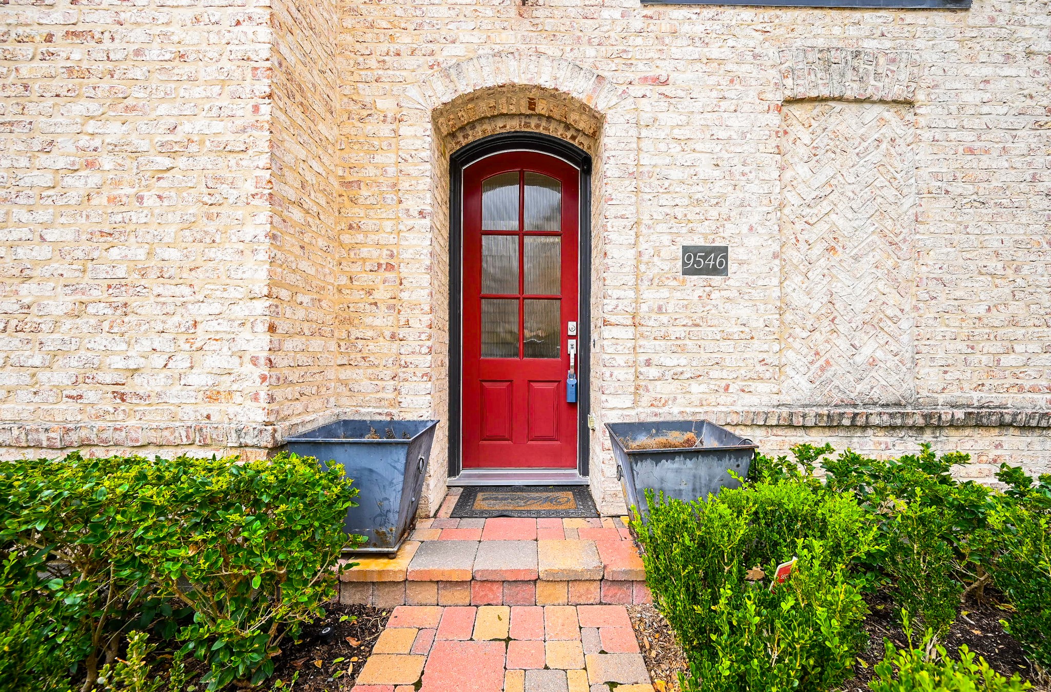 9546 London Bridge Station Houston, TX 77045 - Photo 35 of 41 The European-style 'cottage' covered front entry is both practical and aesthetically pleasing, featuring an artisan-inspired brick and stone exterior facade with a vibrant tile walkway.