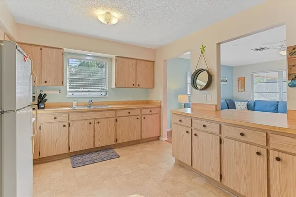 a kitchen with sink cabinets and window